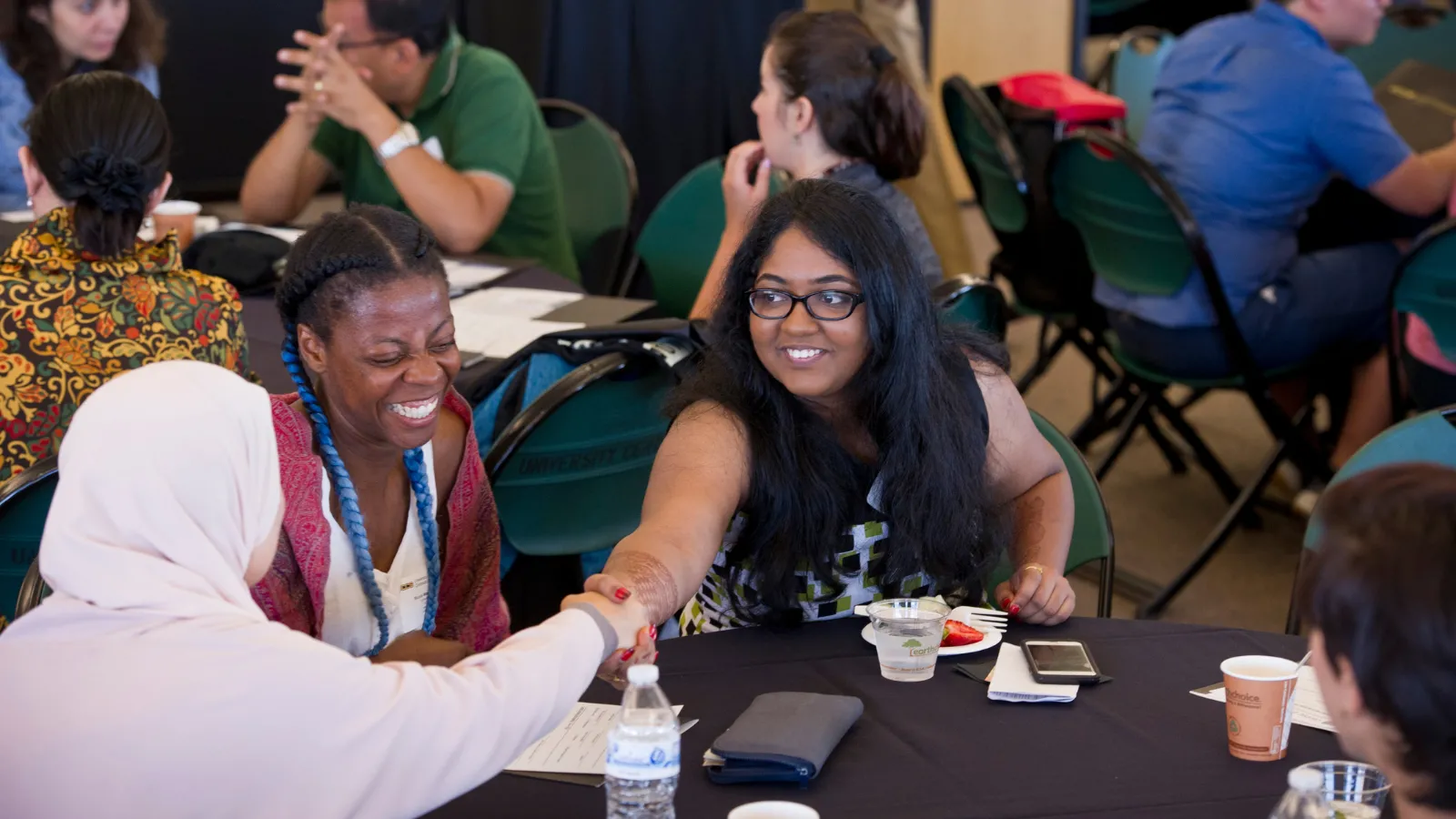 Students shaking hands at event on campus